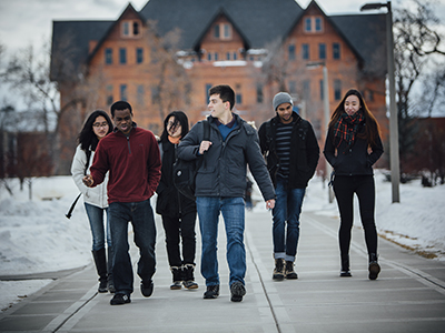 Students walk down the hill from Montana Hall