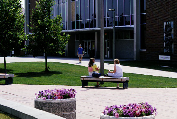 Students sit in front of the library at Montana State University in Bozeman
