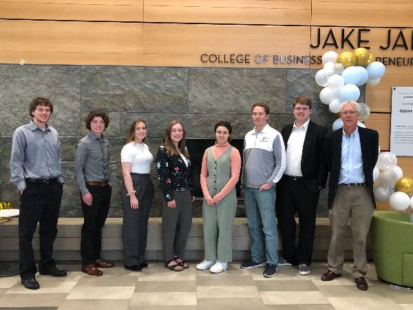 2022 community banking summer interns in front of the fireplace in Jabs Hall