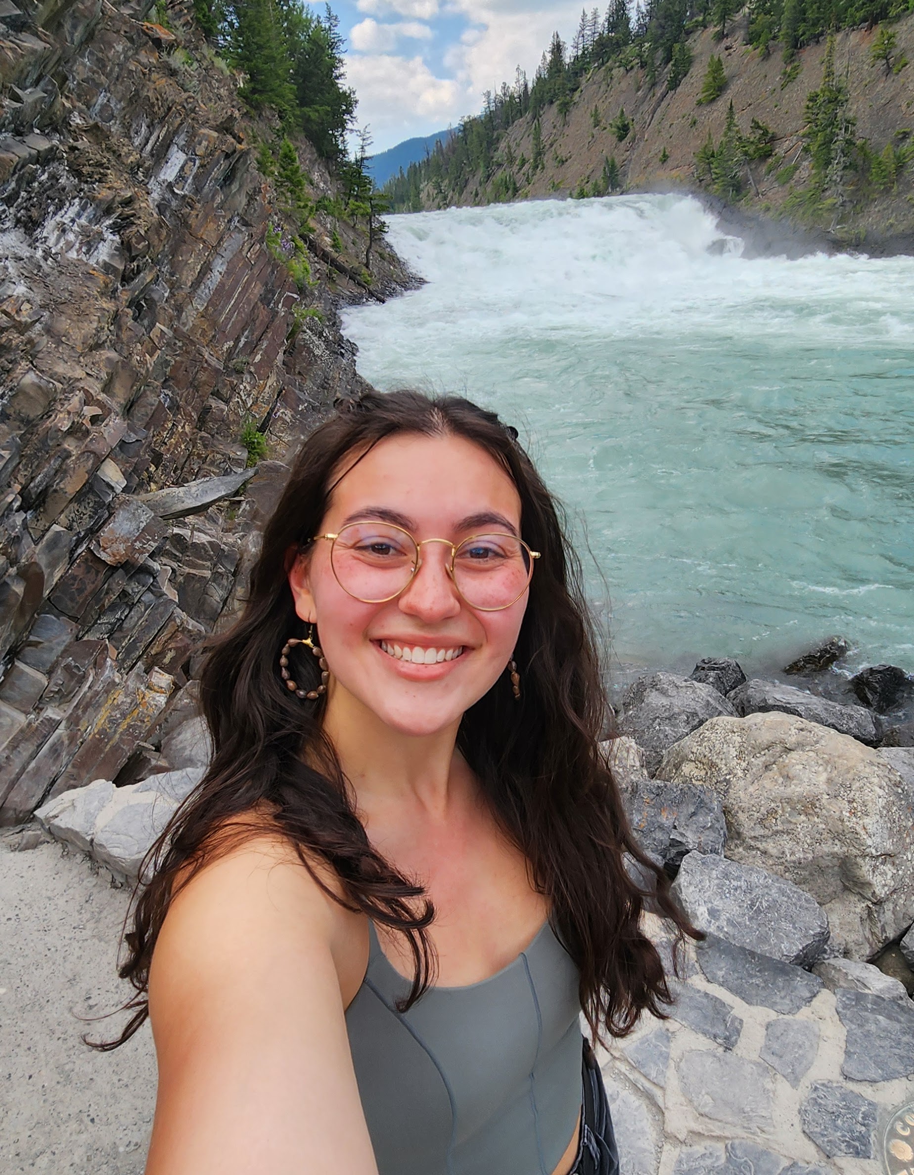 Anneke out in nature with a waterfall behind her