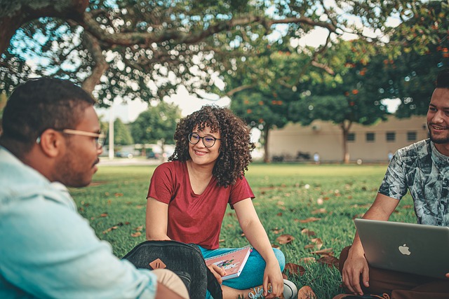 Students sitting outside smiling