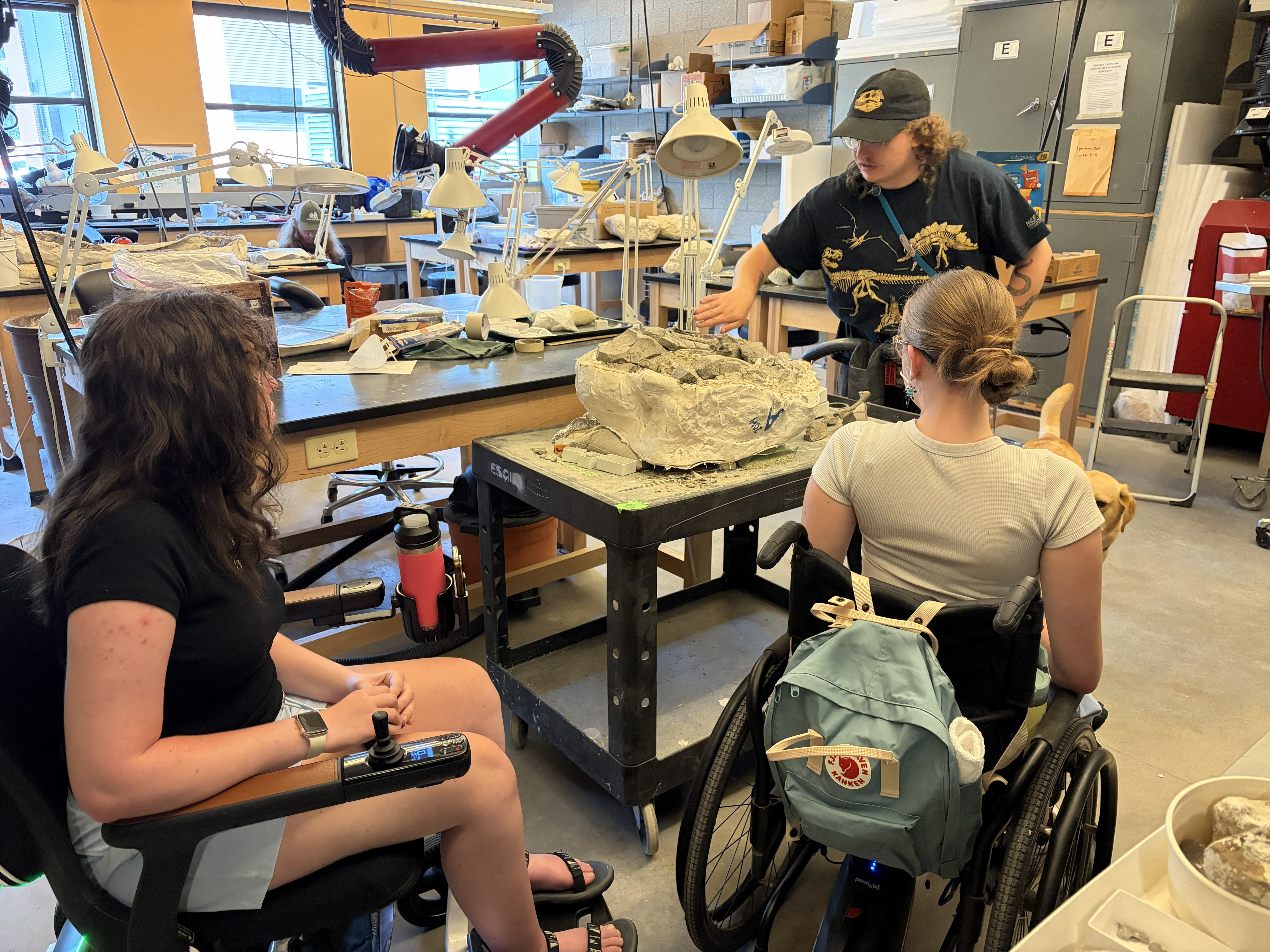 Two wheelchair uses look at fossils