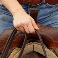 Person on a horse holding reins togther with one hand and they have two fingers through the loop