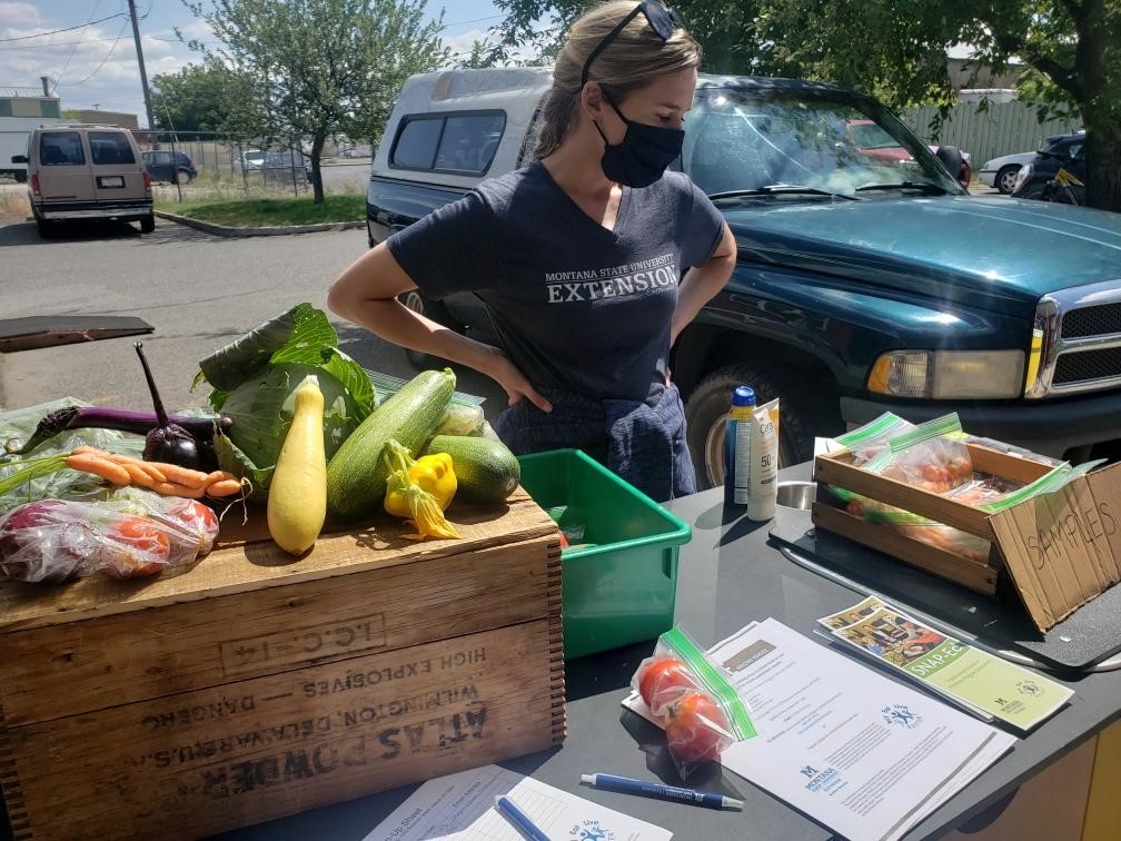 boxes of fruit and veggetables on a table with further information