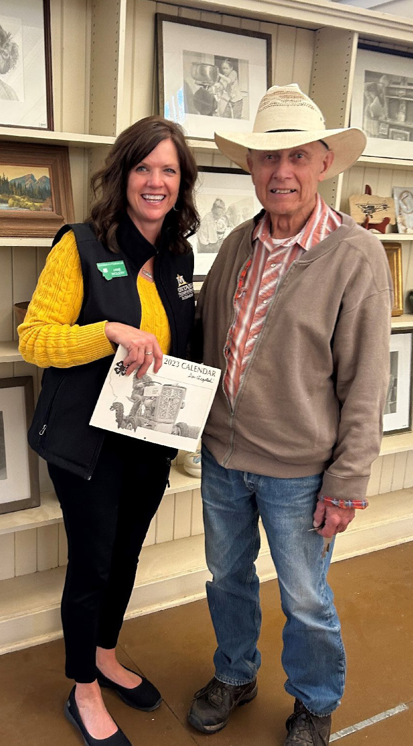 Don Greytak standing with a female extension agent