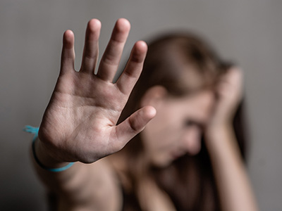 Distressed woman holding up hand in a stop signal