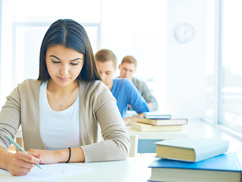 Students writing at desks
