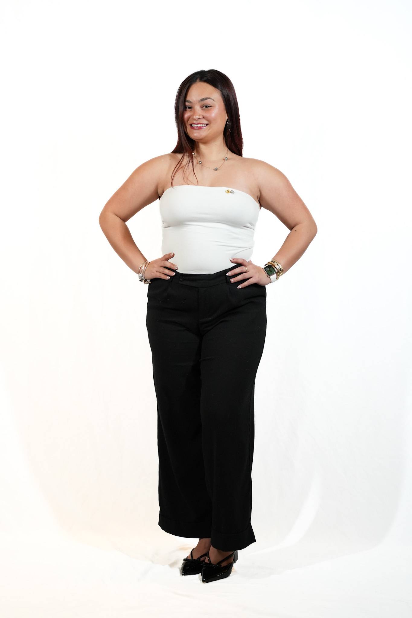 Female student wearing white strapless bouse and black pants