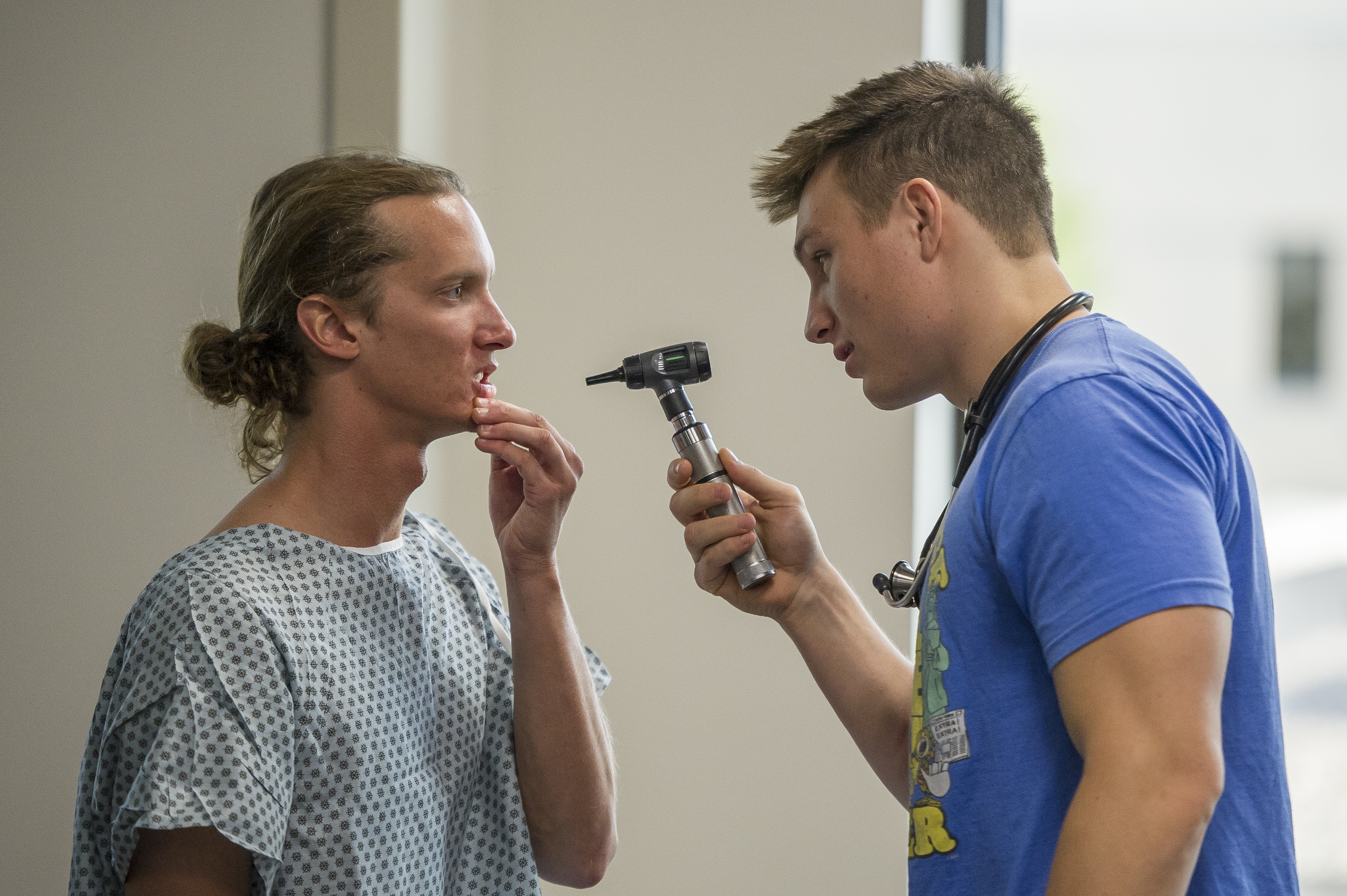 Student checking another student's mouth