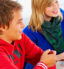 Teens smiling at a table