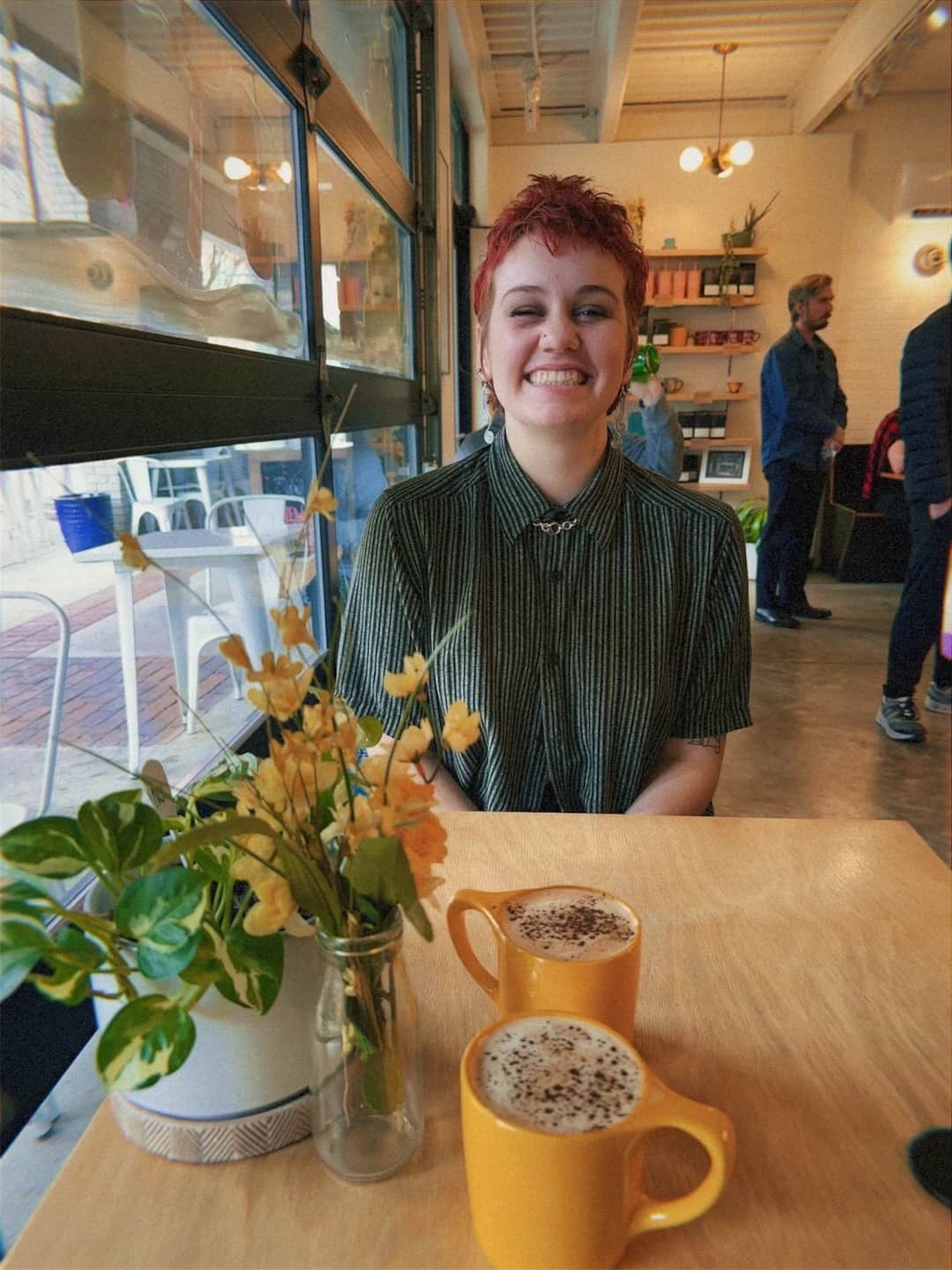 Georgie smiling at a cafe