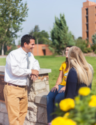 Dean Caires speaking with students