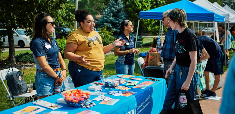 Students hanging out near the Diversity and Inclusion Student Commons booth during Catapalooza.