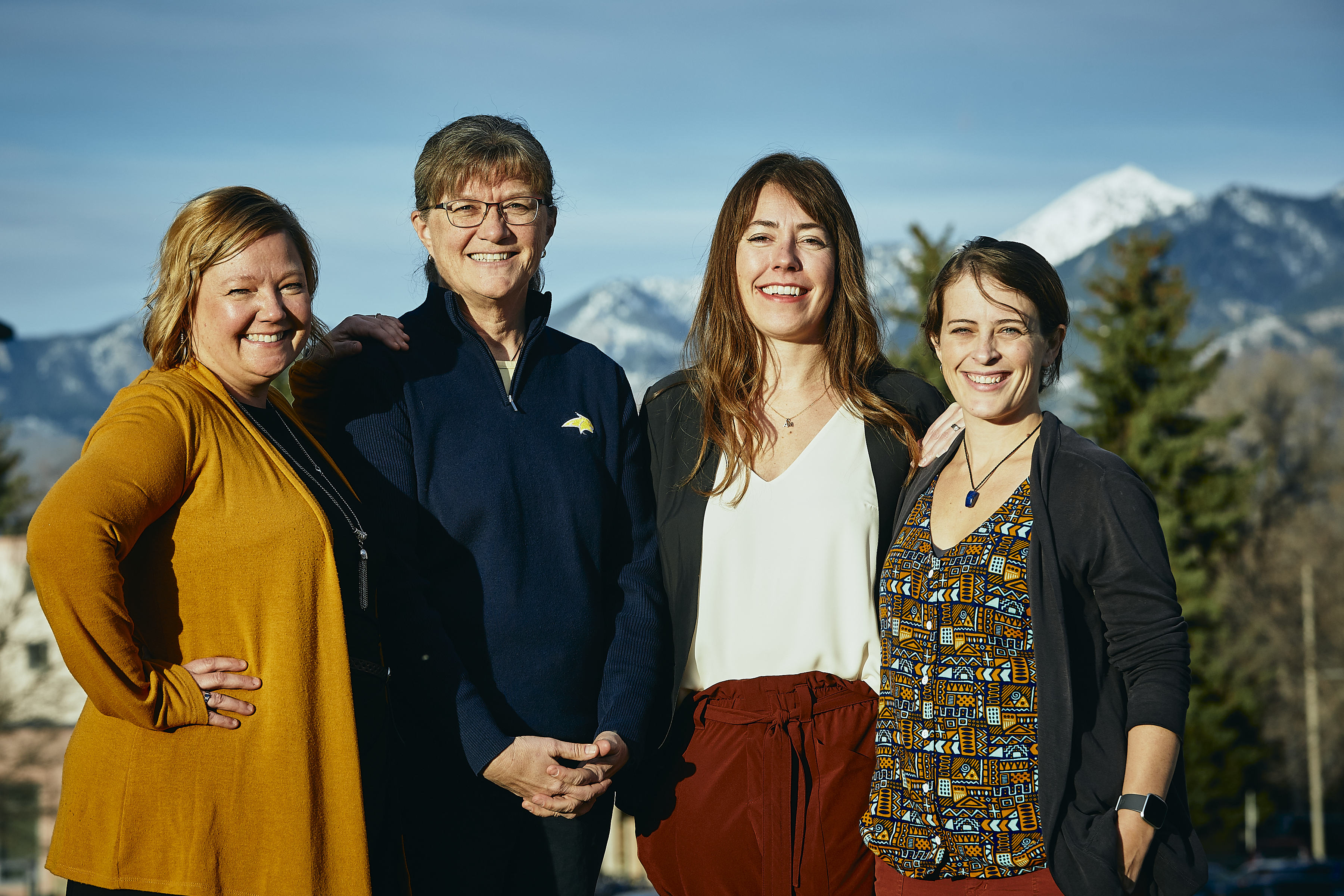 four women with mountains