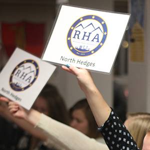 Hands raising placard sign